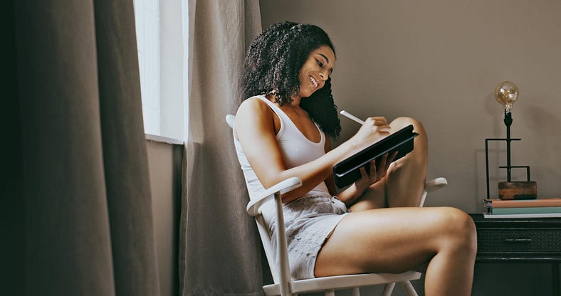 Relax, mindful and black woman writing in her journal in her bedroom for peace. Mental wellness and zen. Notebook, rest and young female relaxing on a chair in her room for a calm and health routine.